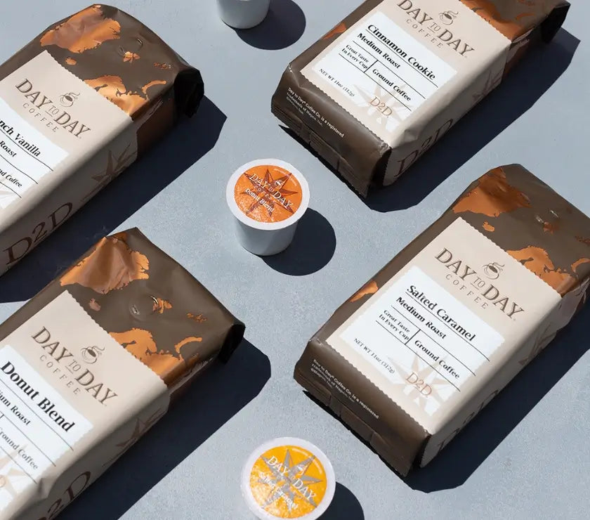 Day to Day Coffee packages with coffee pods on a gray surface