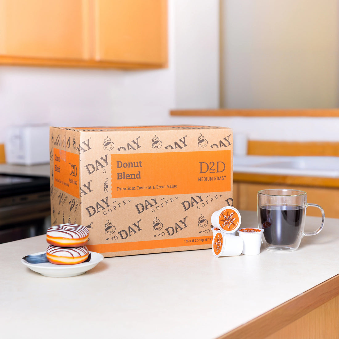 Day to Day Coffee Donut Blend box and glass mug of brewed coffee on kitchen counter – medium roast K-Cups