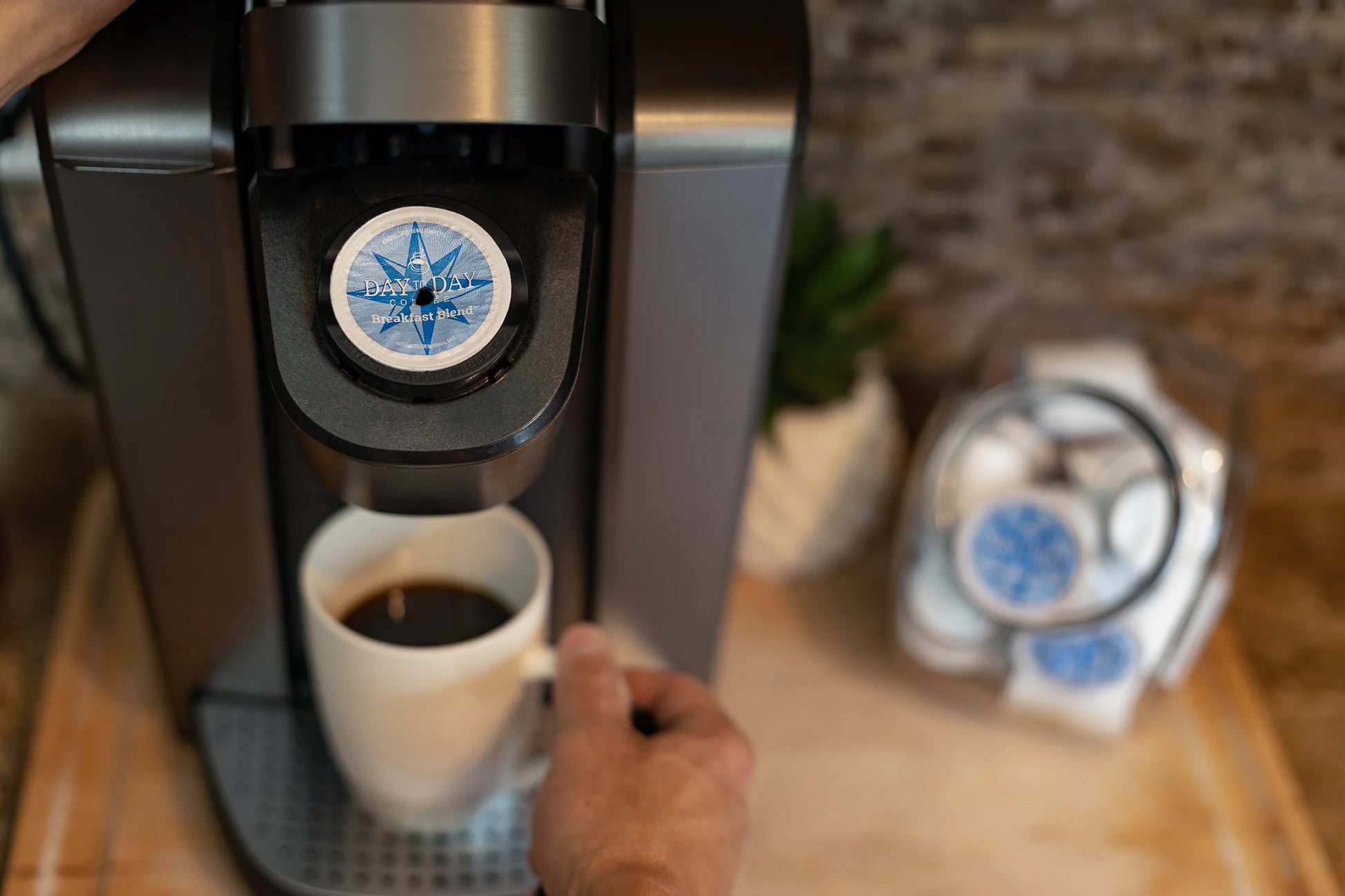 Day to Day Coffee Breakfast Blend K-Cup pods with pink mug and roasted beans on kitchen counter – medium roast
