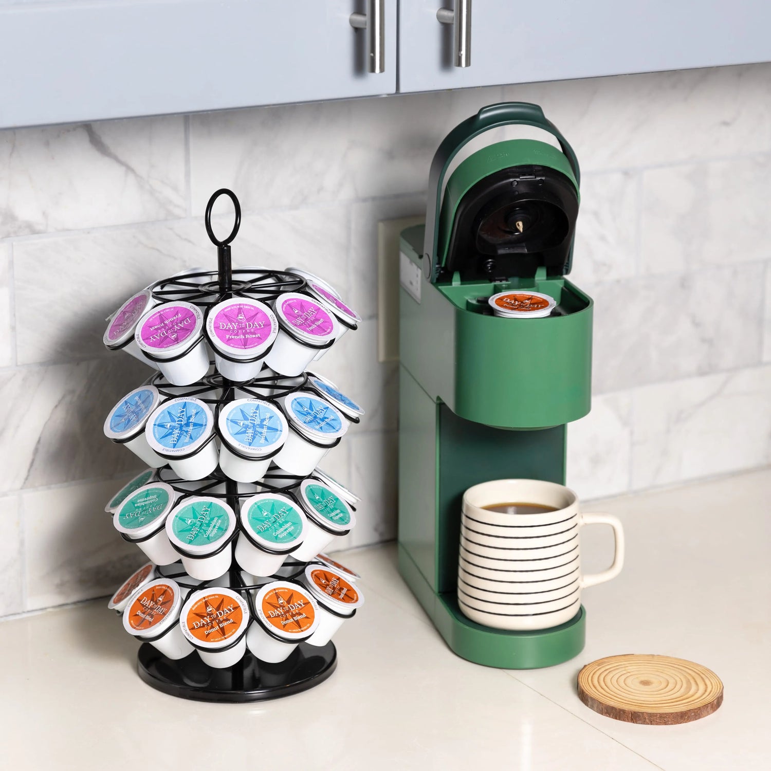 Coffee pod organizer with colorful pods next to a green coffee machine on a kitchen counter.